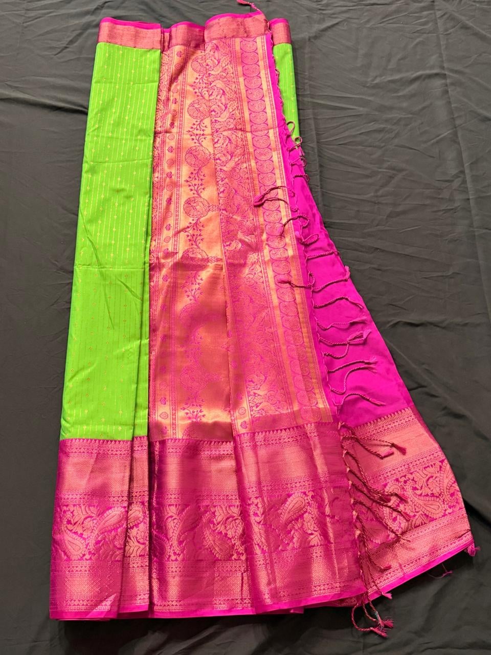 Neon lime green Kanchipuram silk saree with paisley and geometric motifs, magenta decorative border, draped product view