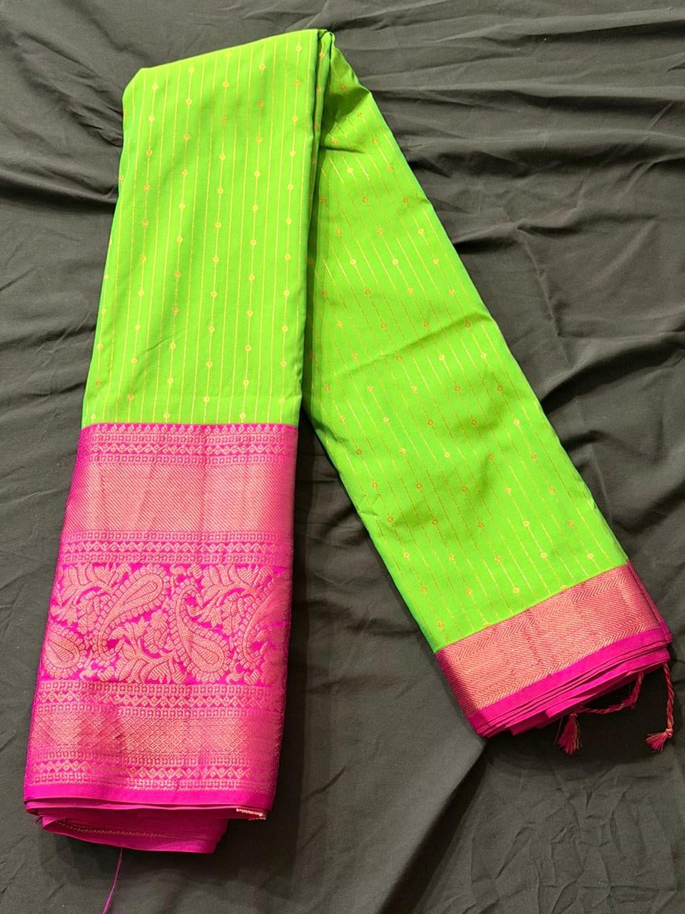 Neon lime green Kanchipuram silk saree with paisley and geometric motifs, fine vertical striped pattern, body detail view