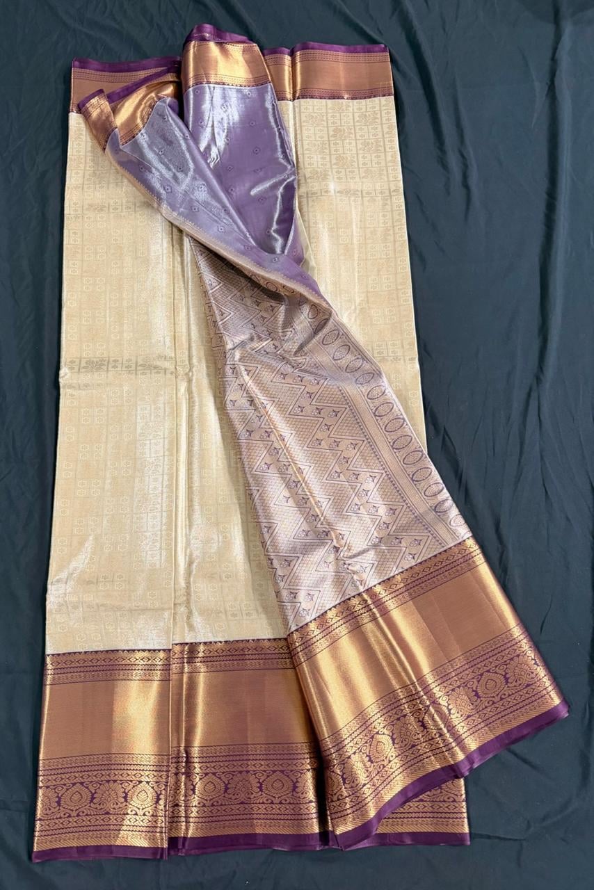 Cream Kanchipuram silk saree with butta motifs and ornate purple-gold border, product view