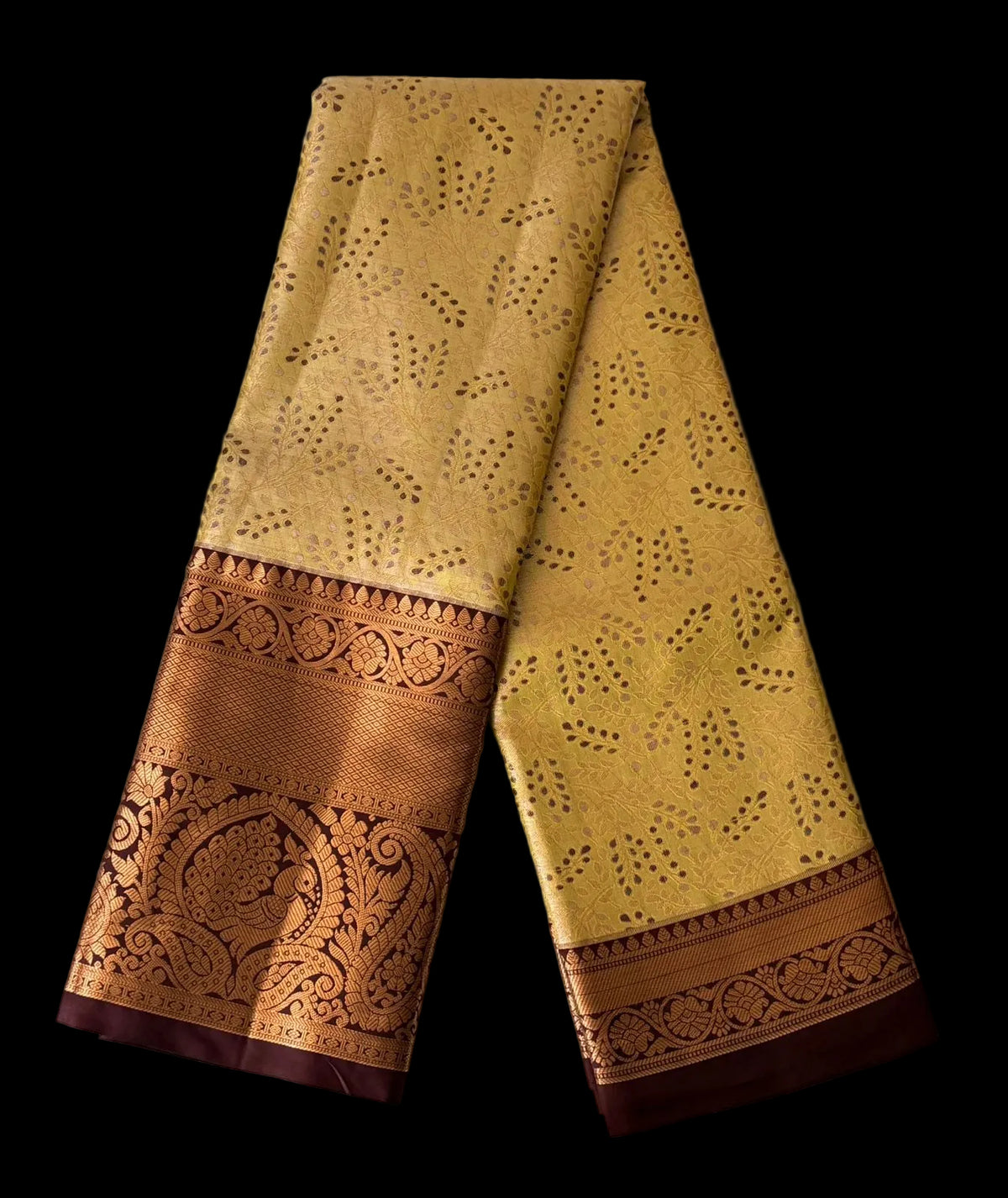 Warm mustard gold Kanchipuram silk saree with geometric butta pattern and chocolate brown ornate border, detail view