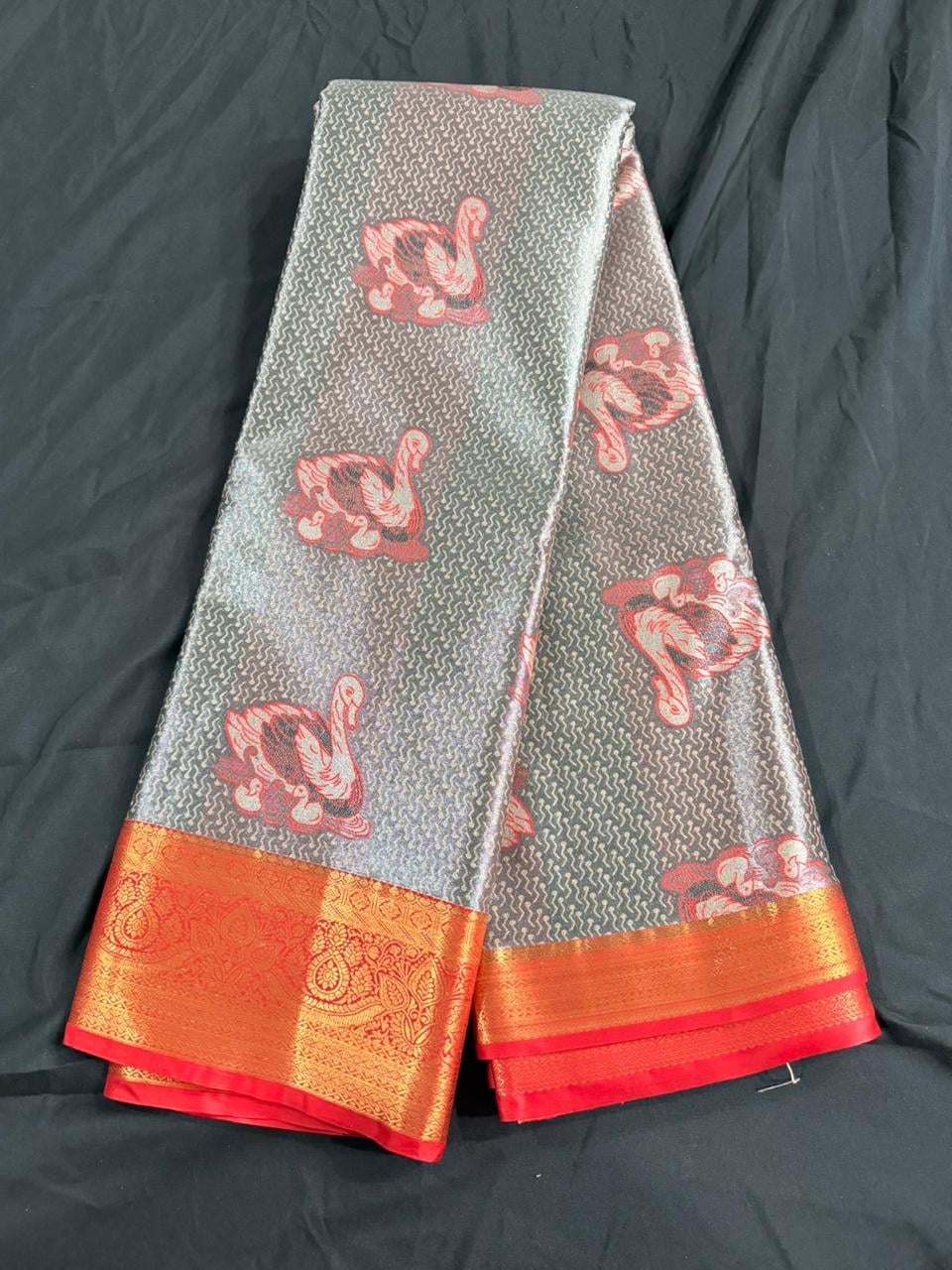 Silver grey Kanchipuram silk saree with peacock motifs and red-gold ornamental border, body detail view