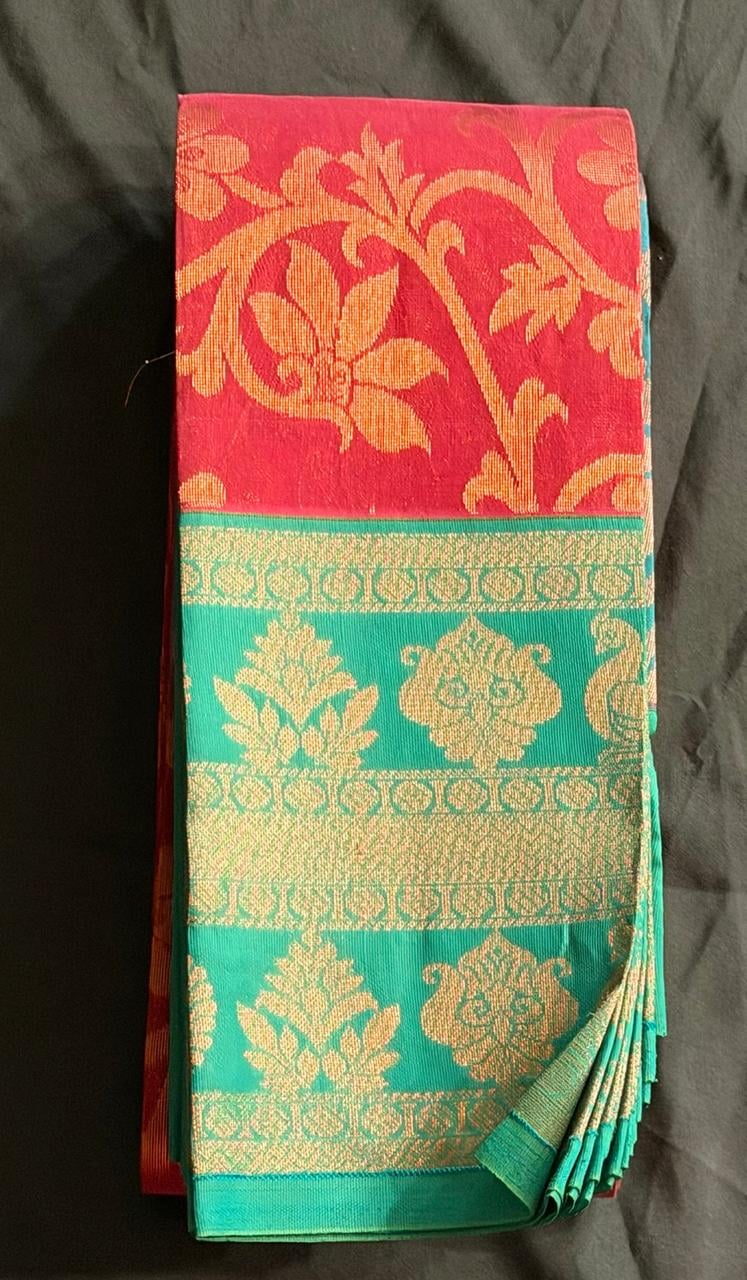 Teal green Organza saree with floral and butta motifs in gold and red-gold border, folded detail view
