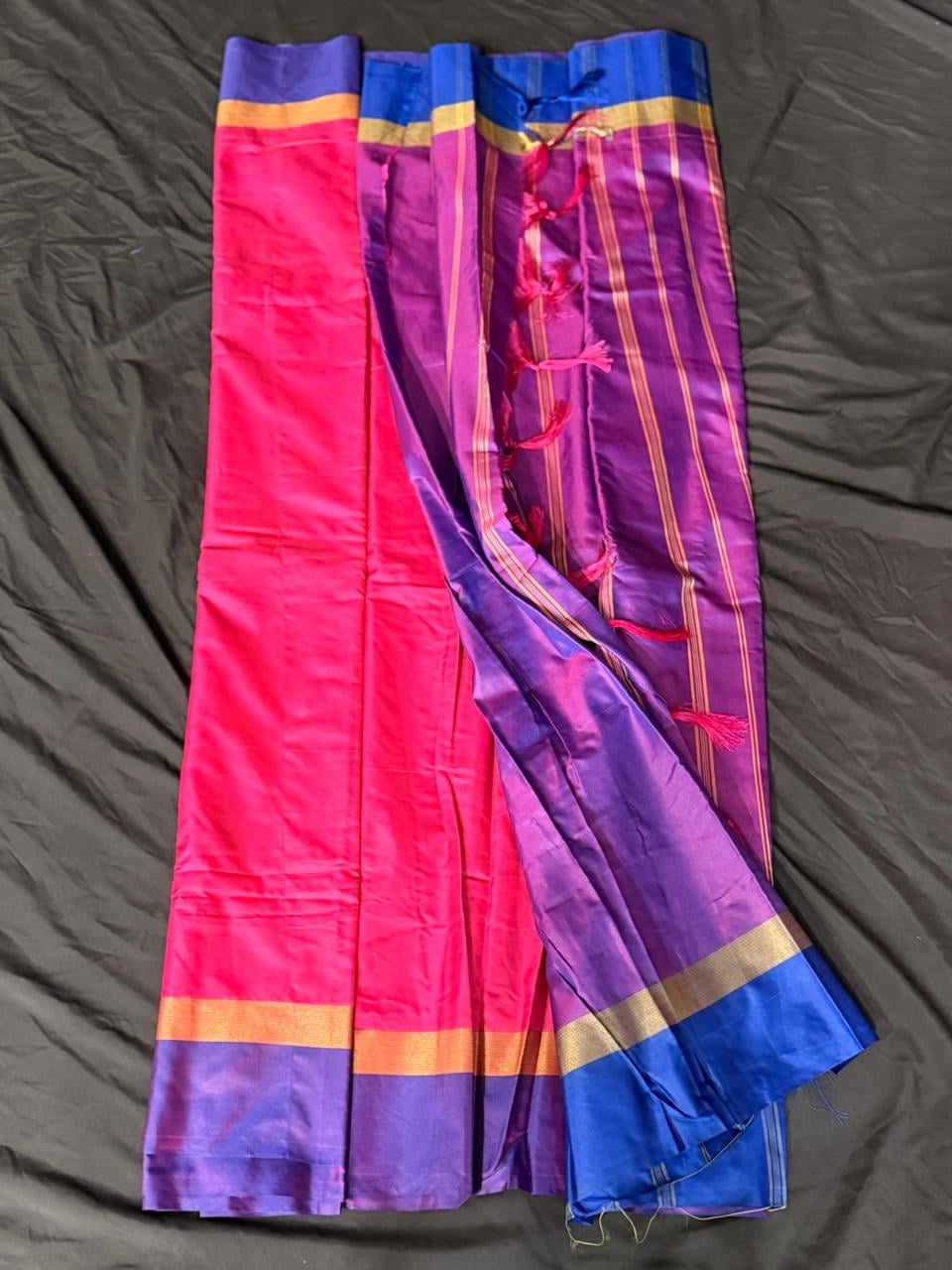 Hot pink color-block saree with royal purple and cobalt blue sections, gold striped border and purple pallu, draped product view