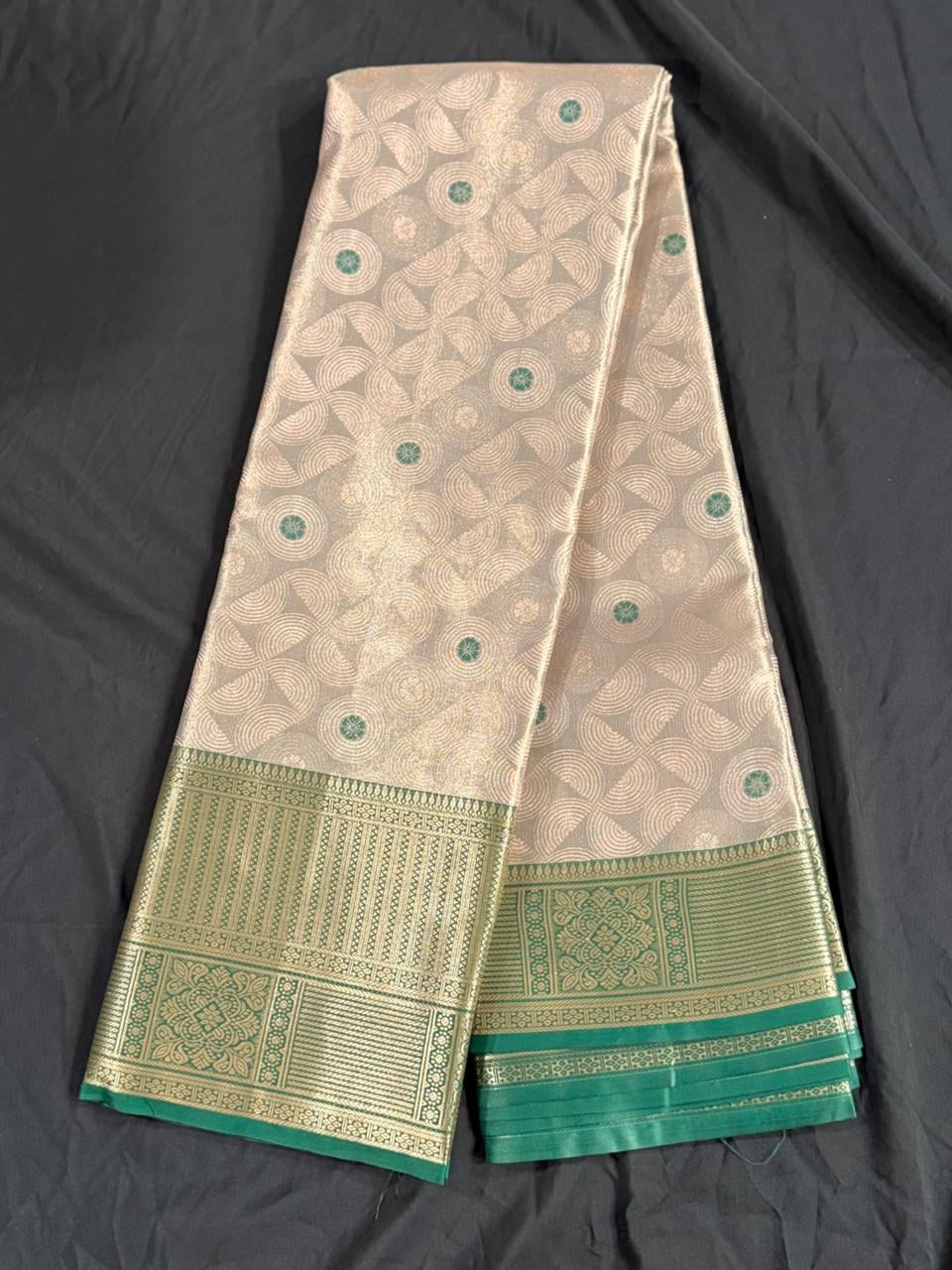 Cream Kanchipuram silk saree with repeating geometric circular motifs and butta elements, body detail view