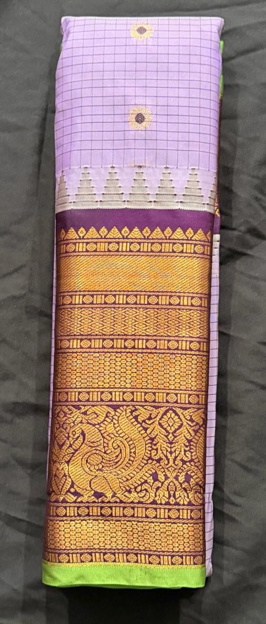 Light orchid purple Kanchipuram silk saree with ornate gold and burgundy border featuring geometric and floral patterns with neon green edge, border detail view