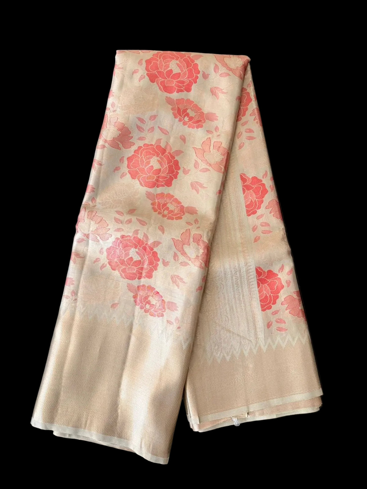 Ivory Kanchipuram silk saree with coral-red peony florals and gold-toned border, detail view