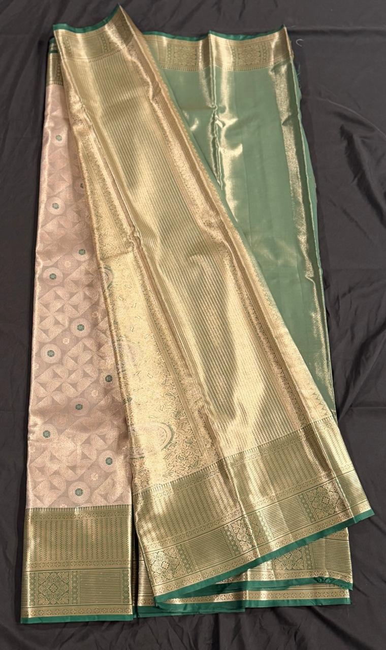 Cream Kanchipuram silk saree with geometric butta motifs and teal green-gold ornate border, draped product view