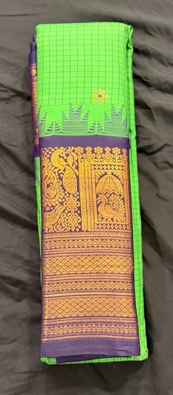 Bright lime green Kanchipuram silk saree with gold and purple patterned pallu, folded detail view