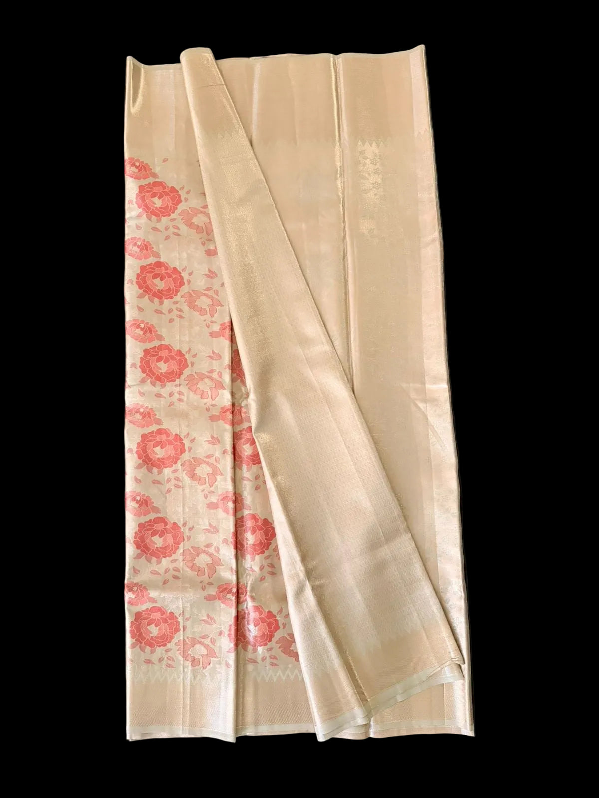 Ivory Kanchipuram silk saree with coral-red peony florals and gold-toned border, draped product view