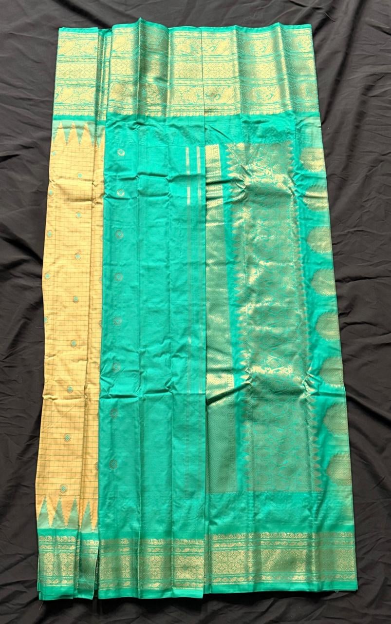 Teal green Kanchipuram silk saree with paisley, geometric and temple motifs in gold on cream grid body, teal-gold ornate border with scalloped detailing, draped product view
