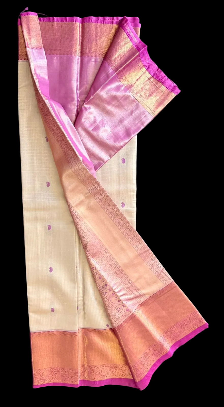 Cream ivory Kanchipuram silk saree with scattered butta motifs and pink-gold woven border, draped product view