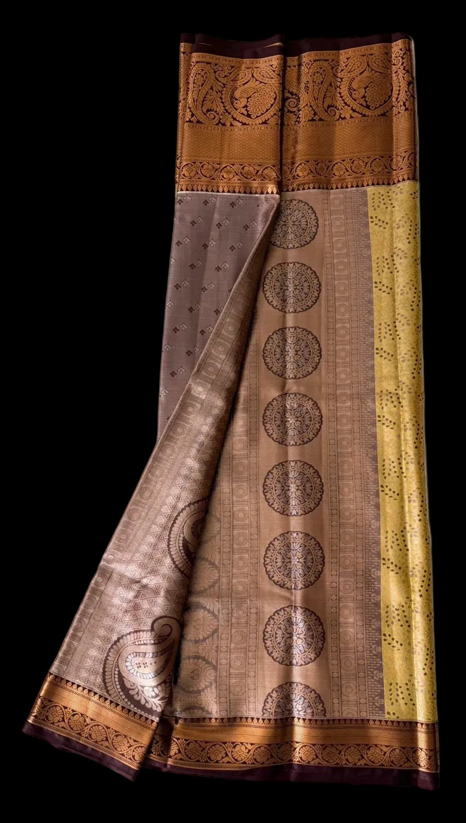 Warm mustard gold Kanchipuram silk saree with scattered butta motifs and ornate brown-gold border, draped product view