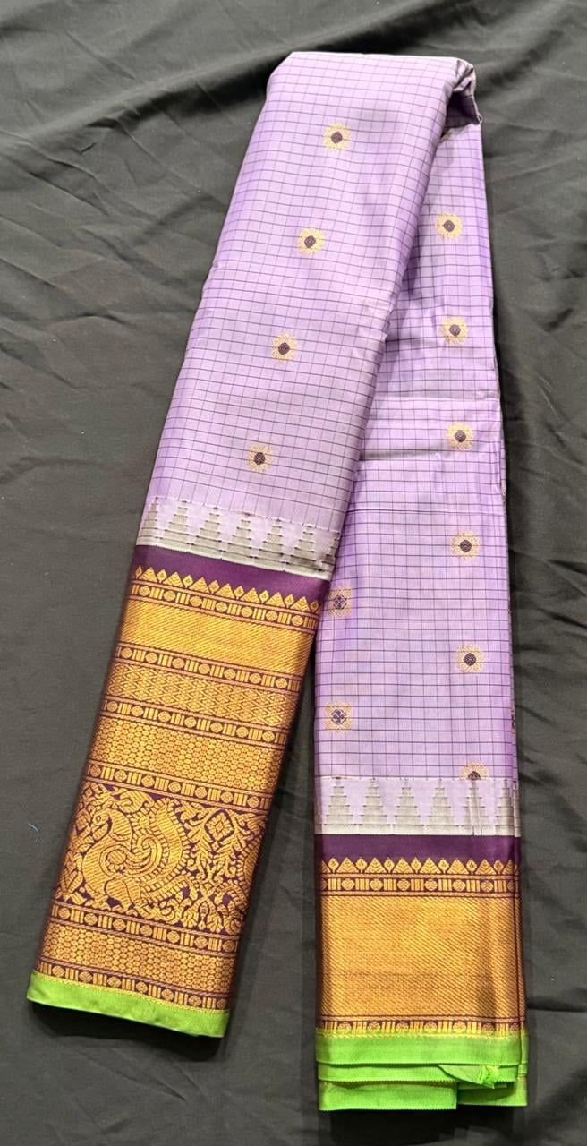 Light orchid purple Kanchipuram silk saree with butta and geometric motifs and ornate gold border, folded detail view