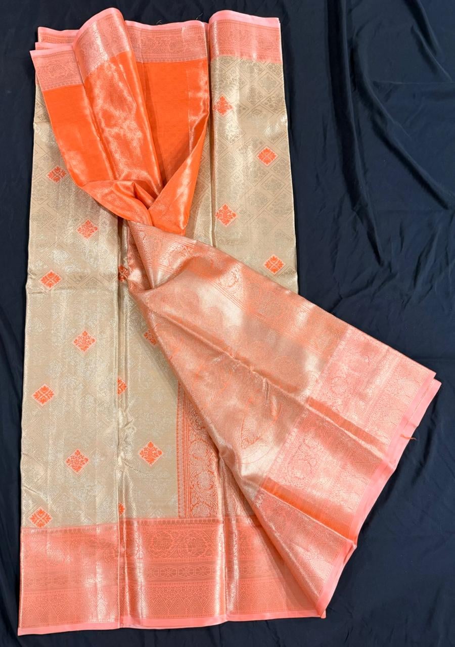 Cream Kanchipuram silk saree with scattered geometric butta motifs in coral-orange and ornate coral-orange border, draped product view