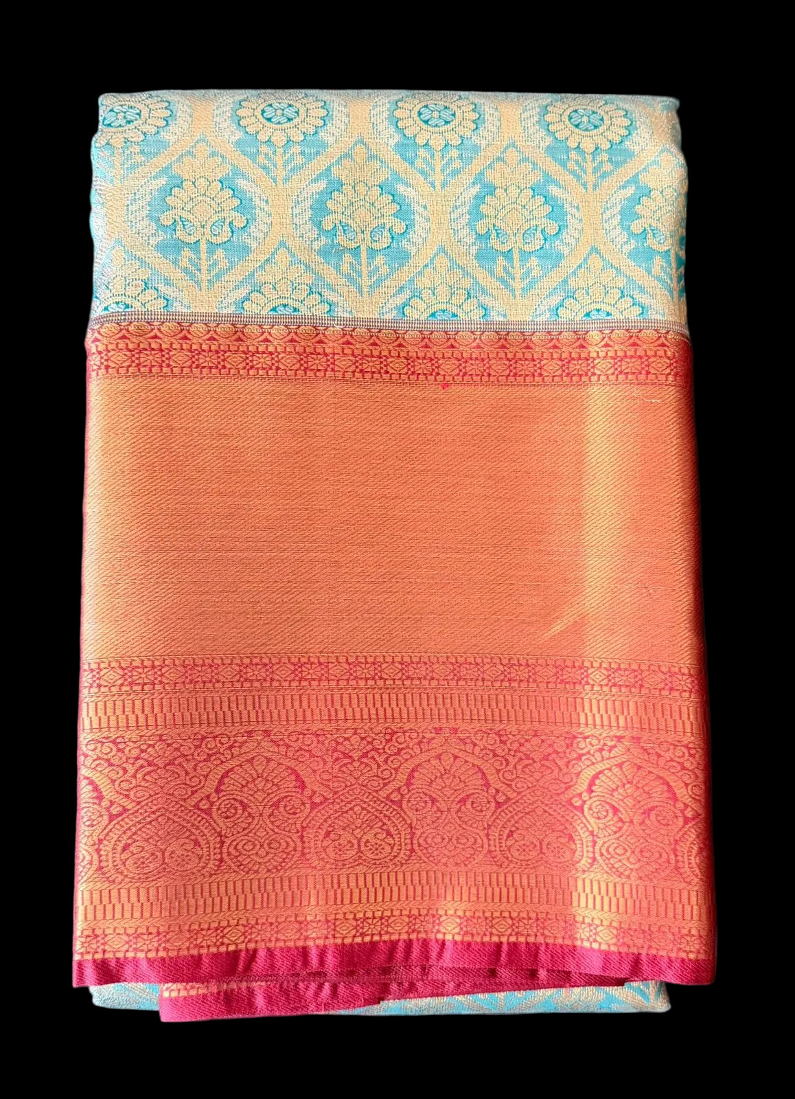 Cream Kanchipuram silk saree with floral and geometric motifs, orange-gold border, folded detail view