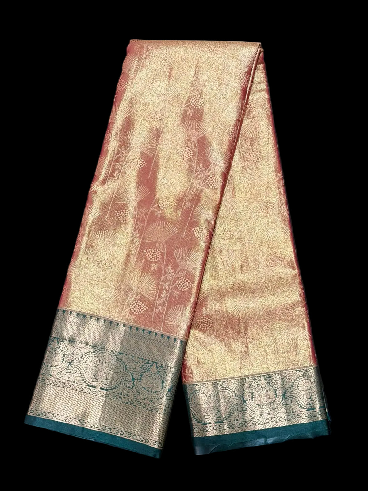 Rust red Kanchipuram silk saree with floral, paisley, and geometric motifs, ornate gold and teal border, detail view