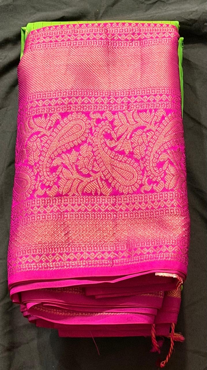 Neon lime green Kanchipuram silk saree with paisley and geometric motifs and magenta border, folded detail view