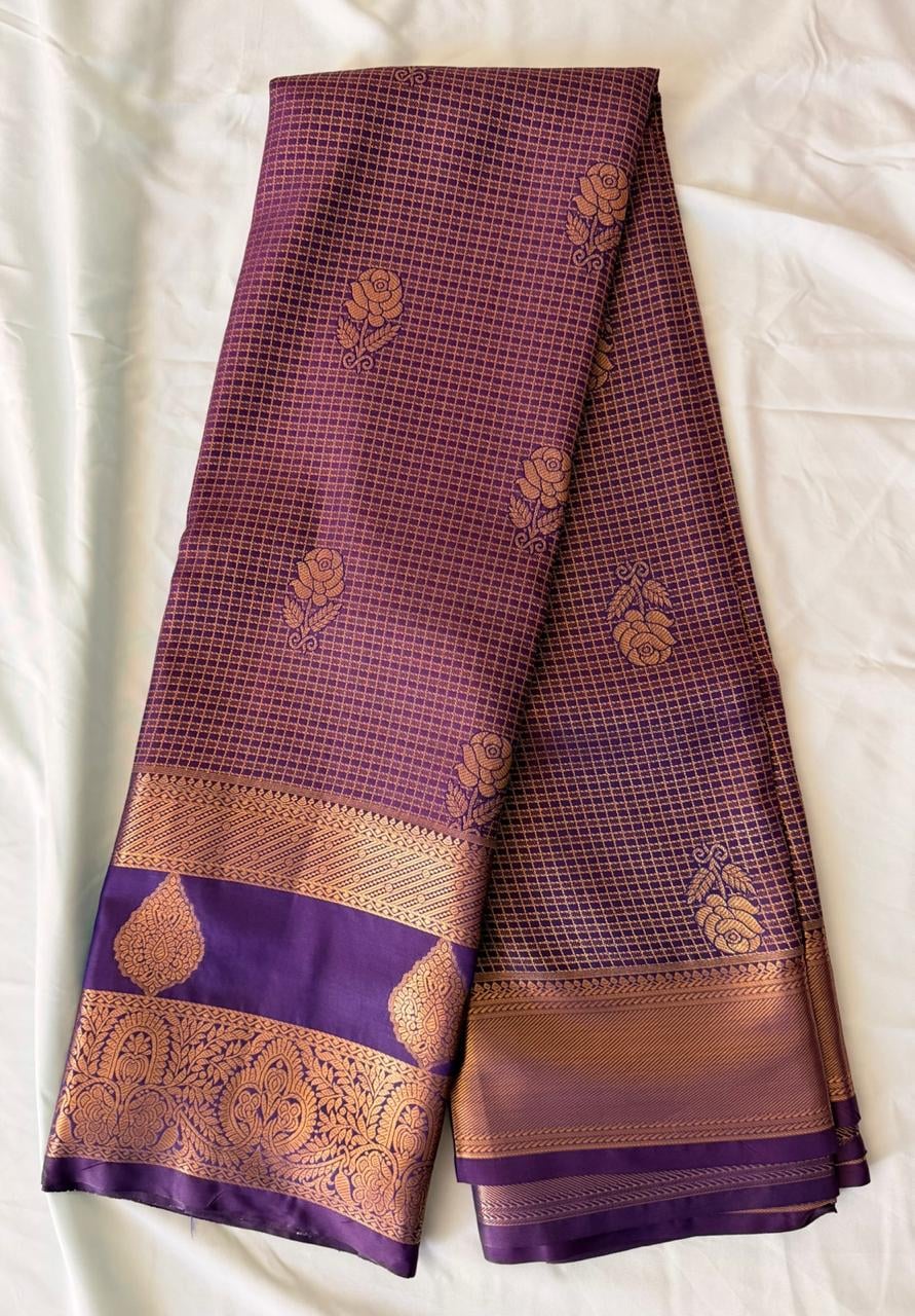 Deep wine purple Kanchipuram silk saree with small repeating checks and scattered floral motifs in gold and copper tones, body detail view