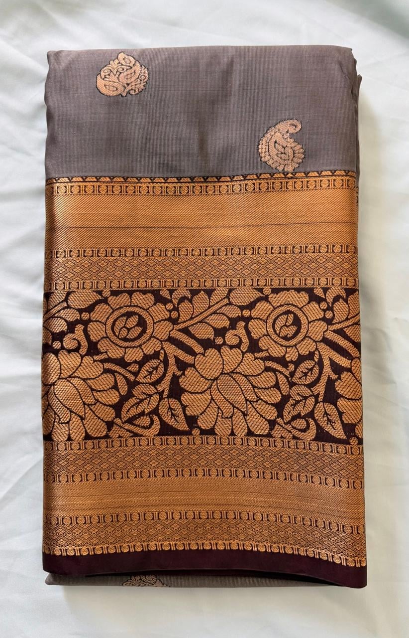 Warm taupe-brown Kanchipuram silk saree with gold butta details and geometric patterned border, product view