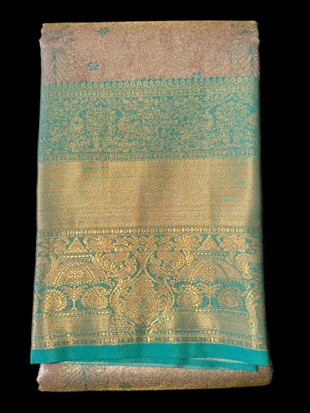 Antique gold Kanchipuram silk saree with teal-gold border and elaborate pallu, folded detail view