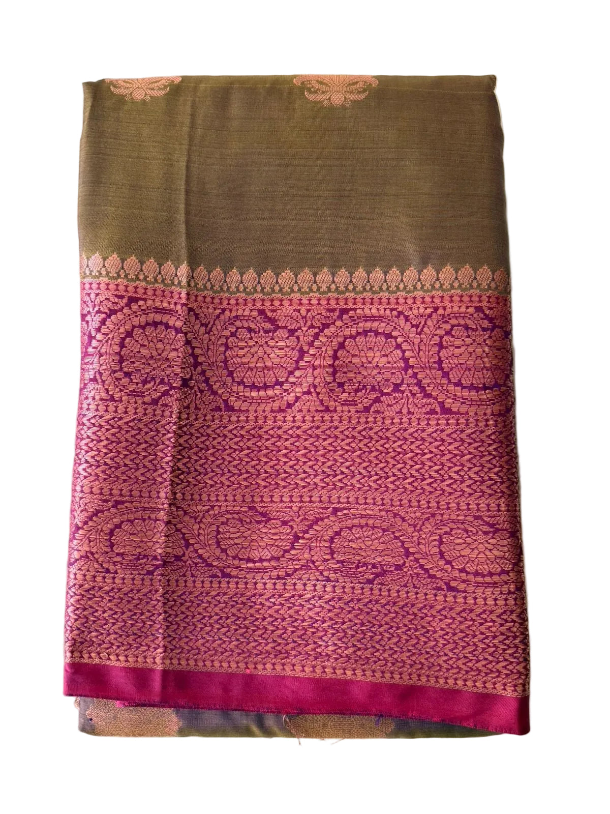 Vibrant pink saree with floral and butta motifs and ornate magenta-gold border, folded detail view